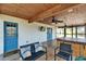 Inviting outdoor patio with ceiling fans, television, seating, and a hot tub at 9118 Brunswick Ln, Tampa, FL 33615