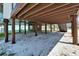 Spacious area underneath the house, supported by sturdy pillars, offering ample parking or storage space at 9118 Brunswick Ln, Tampa, FL 33615