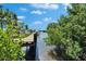 Picturesque waterfront scene featuring a private dock, perfect for boating and enjoying tranquil water views at 9118 Brunswick Ln, Tampa, FL 33615