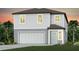 Charming two-story home with a two-car garage, light gray siding, and tropical landscaping at 9951 Trellis Vine Way, Parrish, FL 34219