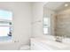 Bright bathroom with a large vanity, modern fixtures, and a shower visible in the mirror at 9955 Trellis Vine Way, Parrish, FL 34219