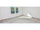 Clean and bright bedroom featuring two windows and neutral carpeting at 9955 Trellis Vine Way, Parrish, FL 34219