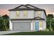 Charming two-story home featuring a gray garage door and a complementary blue front door at 9955 Trellis Vine Way, Parrish, FL 34219