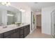 Modern bathroom featuring double sinks, a large mirror, and elegant finishes at 9959 Trellis Vine Way, Parrish, FL 34219