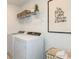 Functional laundry room with modern washer and dryer units at 9959 Trellis Vine Way, Parrish, FL 34219