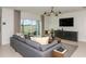 Cozy living room featuring a comfortable sofa, modern decor, and natural light at 9959 Trellis Vine Way, Parrish, FL 34219