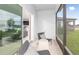 Relaxing screened patio with stylish outdoor furniture and a serene view of the surrounding landscape and kitchen at 9959 Trellis Vine Way, Parrish, FL 34219