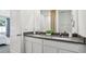 Bathroom featuring a double vanity, gray countertop, white cabinets and decorative accents at 1004 Spotted Egret Loop, Ruskin, FL 33570