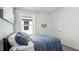 Bright bedroom featuring a plush bed, sheer curtains, and a modern decor at 1004 Spotted Egret Loop, Ruskin, FL 33570