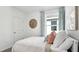 Well-appointed bedroom with a stylish bed, accent wall, and plenty of natural light at 1004 Spotted Egret Loop, Ruskin, FL 33570