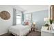 Well-lit bedroom with stylish decor, a cozy bed, and a large window for natural light at 1004 Spotted Egret Loop, Ruskin, FL 33570