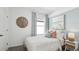 Inviting bedroom featuring a comfortable bed, accent wall, and ample natural light from a large window at 1004 Spotted Egret Loop, Ruskin, FL 33570