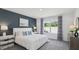 Bedroom featuring a white bed, navy accent wall, and large window at 1004 Spotted Egret Loop, Ruskin, FL 33570