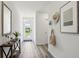 Bright hallway with wood floors, decorative accents, and a clear view to the front door at 1004 Spotted Egret Loop, Ruskin, FL 33570