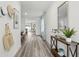 Inviting hallway showcasing wood floors and an open layout leading to the dining and living areas at 1004 Spotted Egret Loop, Ruskin, FL 33570