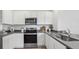 Modern kitchen with stainless steel appliances, white cabinets, and gray countertops for a clean design at 1004 Spotted Egret Lk, Ruskin, FL 33570