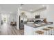 Spacious kitchen with stainless appliances, light cabinetry, breakfast bar and open floor plan to dining area at 1004 Spotted Egret Loop, Ruskin, FL 33570