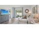 Cozy living room featuring comfortable seating, stylish decor, and sliding glass doors to the outside at 1004 Spotted Egret Loop, Ruskin, FL 33570