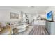Bright and open living space seamlessly connected to the kitchen area with modern countertops at 1004 Spotted Egret Loop, Ruskin, FL 33570