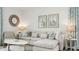 Living room features a sectional sofa with elegant coastal decor and modern furnishings at 1004 Spotted Egret Loop, Ruskin, FL 33570