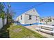 Backyard featuring green space, a brick patio, and a picnic table, perfect for outdoor relaxation at 101 146Th Ave, Madeira Beach, FL 33708
