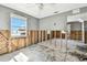 Bedroom featuring a window overlooking a beach view, complemented by ceiling fan at 101 146Th Ave, Madeira Beach, FL 33708