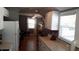 Kitchen extending into a living room with warm wood floors and a window at 101 146Th Ave, Madeira Beach, FL 33708