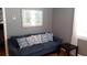 Living room featuring a blue couch with patterned pillows, complemented by a dark end table at 101 146Th Ave, Madeira Beach, FL 33708