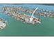 Attractive aerial view showcasing the property’s location on the water with lush landscaping, boat dock at 11050 7Th E St, Treasure Island, FL 33706