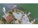 Aerial view of home featuring a pool, boat dock, surrounding lawns, and adjacent waterfront properties at 11050 7Th E St, Treasure Island, FL 33706