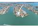 Attractive aerial view showcasing the property’s location on the water with lush landscaping, boat dock at 11050 7Th E St, Treasure Island, FL 33706