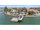 Beautiful waterfront home boasts a private boat dock, sparkling pool, and lush landscaping at 11050 7Th E St, Treasure Island, FL 33706