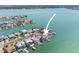 Captivating aerial view of waterfront property featuring boat docks, lush landscaping, and pristine waterways at 11050 7Th E St, Treasure Island, FL 33706