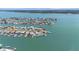 A bird's eye view of a waterfront community with picturesque homes, private boat docks, and serene waterways at 11050 7Th E St, Treasure Island, FL 33706