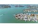 Scenic aerial view of the community and home showcasing waterfront access, boat docks, and beautiful surroundings at 11050 7Th E St, Treasure Island, FL 33706