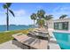 Lounge chairs and lush backyard with waterfront views at 11050 7Th E St, Treasure Island, FL 33706