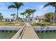 Waterfront home with a private dock, lush landscaping, and a tranquil backyard oasis at 11050 7Th E St, Treasure Island, FL 33706