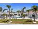 Stunning backyard featuring a refreshing pool, well-manicured lawn, lounge area and modern home exterior at 11050 7Th E St, Treasure Island, FL 33706