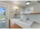 Bathroom with double vanity and access to waterfront views at 11050 7Th E St, Treasure Island, FL 33706