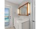 Bathroom with quartz vanity and framed mirror with door to pool at 11050 7Th E St, Treasure Island, FL 33706