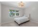 Bedroom with a beautiful water view, a pool view, and stylish light fixture at 11050 7Th E St, Treasure Island, FL 33706
