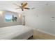 Bedroom features light floors, ceiling fan and water views at 11050 7Th E St, Treasure Island, FL 33706