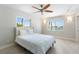 Bedroom featuring water views, modern ceiling fan, and stylish wall lighting at 11050 7Th E St, Treasure Island, FL 33706