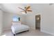 Bright bedroom with ceiling fan and a view of the neighborhood at 11050 7Th E St, Treasure Island, FL 33706