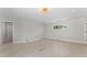 Bright bedroom featuring modern floors and decorative chandelier lighting with views from the window at 11050 7Th E St, Treasure Island, FL 33706