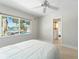 Bright bedroom featuring a pool view and access to an ensuite bathroom at 11050 7Th E St, Treasure Island, FL 33706