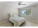 Light bedroom showcasing water views and an elegant white ceiling fan at 11050 7Th E St, Treasure Island, FL 33706