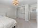 Bright bedroom with an organized closet system and modern ceiling fan with light at 11050 7Th E St, Treasure Island, FL 33706