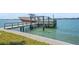 Waterfront property featuring a boat lift for easy access to the water and boating adventures at 11050 7Th E St, Treasure Island, FL 33706