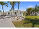 This home offers lush tropical landscaping and a new white pebble perimeter at 11050 7Th E St, Treasure Island, FL 33706